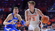 Feb 11, 2025; Champaign, Illinois, USA;  Illinois Fighting Illini forward Ben Humrichous (3) drives the ball past UCLA Bruins forward Tyler Bilodeau (34) during the first half at State Farm Center. Mandatory Credit: Ron Johnson-Imagn Images