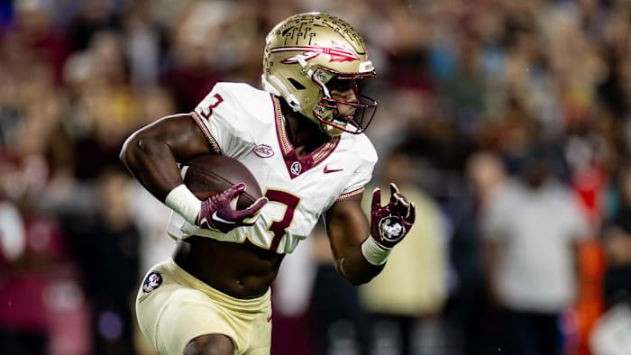 Florida State Seminoles running back Trey Benson (3) rushes with the ball.