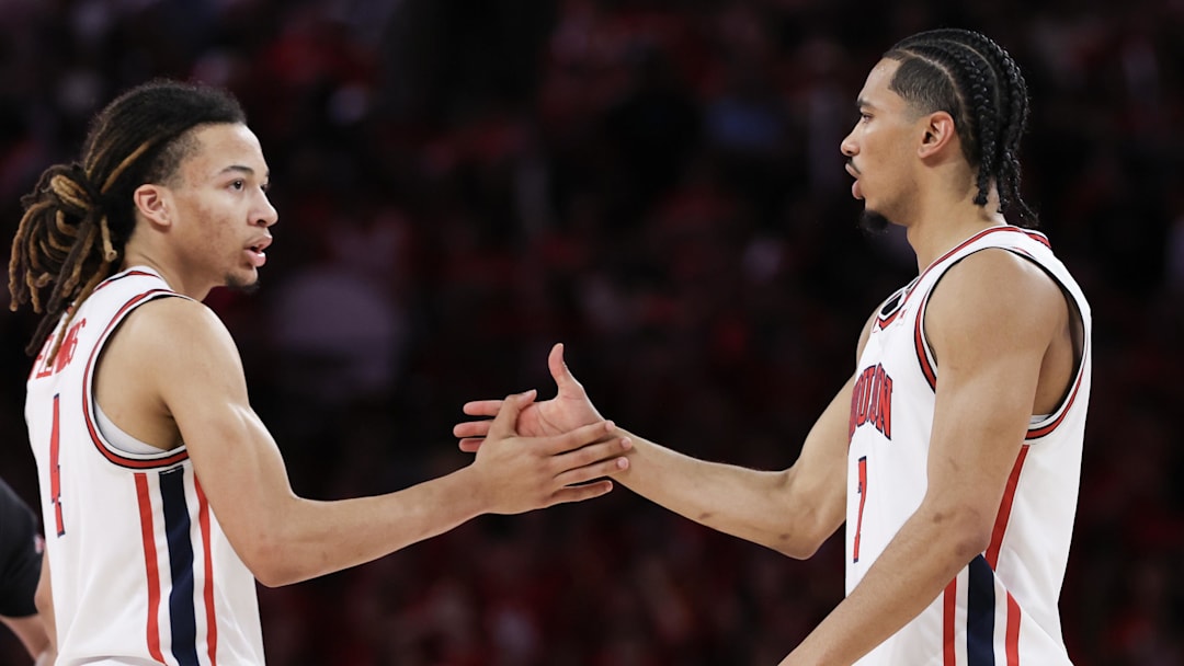 Mar 4, 2026; Houston, Texas, USA; Houston Cougars guard Kingston Flemings (4) shakes hands with  guard Milos Uzan (7) against the Baylor Bears in the second half at Fertitta Center. 