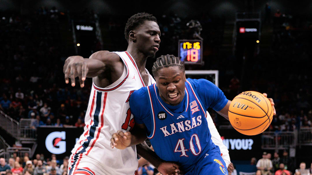 Mar 13, 2026; Kansas City, MO, USA; Kansas Jayhawks forward Flory Bidunga (40) drives to the basket around Houston Cougars forward Kalifa Sakho (14) during the second half at T-Mobile Center. Mandatory Credit: William Purnell-Imagn Images
