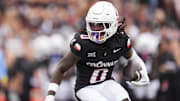 Sep 13, 2025; Cincinnati, Ohio, USA;  Cincinnati Bearcats wide receiver Isaiah Johnson (0) carries the ball for a touchdown against the Northwestern State Demons in the first half at Nippert Stadium. Mandatory Credit: Aaron Doster-Imagn Images