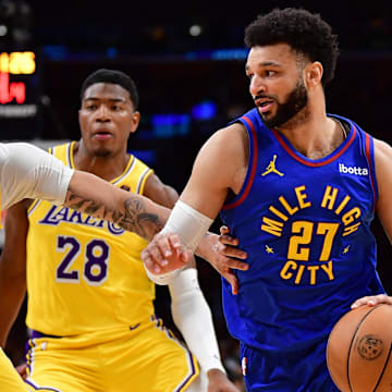 Denver Nuggets guard Jamal Murray (27) moves the ball Los Angeles Lakers forward Anthony Davis (3) and forward Rui Hachimura (28) during the first half in game three of the first round for the 2024 NBA playoffs at Crypto.com Arena. Mandatory Credit: Gary A. Vasquez-Imagn Images