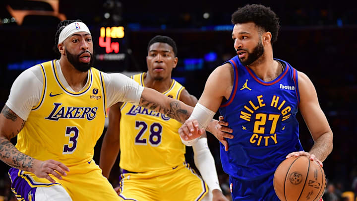 Denver Nuggets guard Jamal Murray (27) moves the ball Los Angeles Lakers forward Anthony Davis (3) and forward Rui Hachimura (28) during the first half in game three of the first round for the 2024 NBA playoffs at Crypto.com Arena. Mandatory Credit: Gary A. Vasquez-Imagn Images