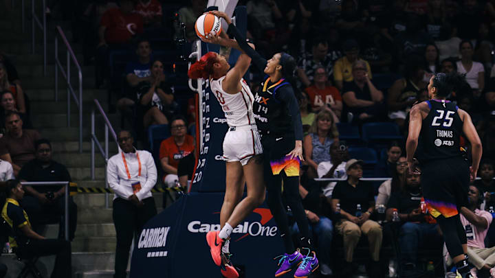Jul 27, 2025; Washington, District of Columbia, USA; Phoenix Mercury forward DeWanna Bonner (14) blocks a shot by Washington Mystics forward Shakira Austin (0) in the third quarter at CareFirst Arena. Mandatory Credit: Emily Faith Morgan-Imagn Images