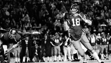 Ole Miss Rebels quarterback Archie Manning (18) looks for a receiver against Vanderbilt.