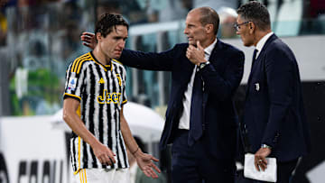 Federico Chiesa (L) of Juventus FC receives a pat on the...