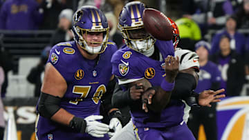 Bengals Joseph Ossai (58) helps take down Ravens Lamar Jackson (8) for the Bengals to take the ball during their game against the Ravens at M&T Bank Stadium on Thanksgiving Thursday November 27, 2025.