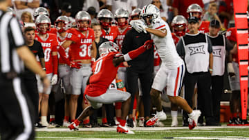 Aug 31, 2024; Tucson, Arizona, USA; Arizona Wildcats wide receiver Tetairoa McMillan (4) dodges tackle from New Mexico Lobos center back Bobby Arnold III (0) during fourth quarter at Arizona Stadium.