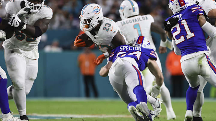 Jan 7, 2024; Miami Gardens, Florida, USA; Miami Dolphins running back Jeff Wilson Jr. (23) runs with the football as Buffalo Bills linebacker Baylon Spector (54) attempts a tackle during the second quarter at Hard Rock Stadium.