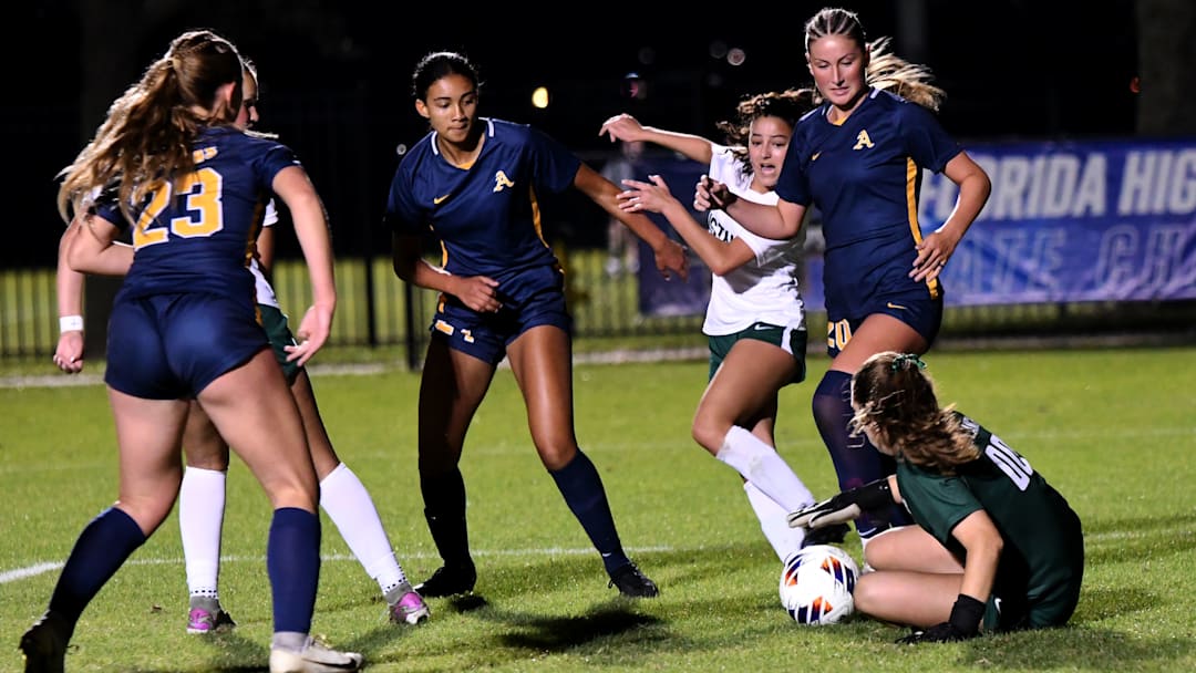 St. Thomas Aquinas and Lakewood Ranch players scramble for a loose ball in front of the net before the ball is eventually gobbled up by the Lakewood goalkeeper. STA won the Class 6A state semifinal, 2-0, at Lake Myrtle Sports Complex on Thursday.