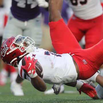 Arizona Wildcats running back Quali Conley (7) lunges for the end zone during the first quarter of the game against Kansas State at Bill Snyder Family Stadium Friday, September 13, 2024.