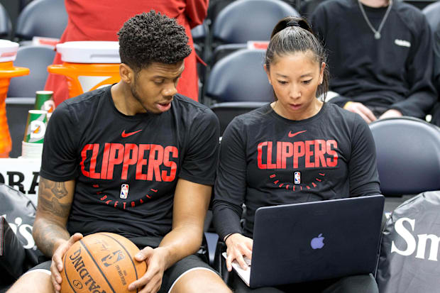 LA Clippers guard Tyrone Wallace reviews video with assistant coach Natalie Nakase. 