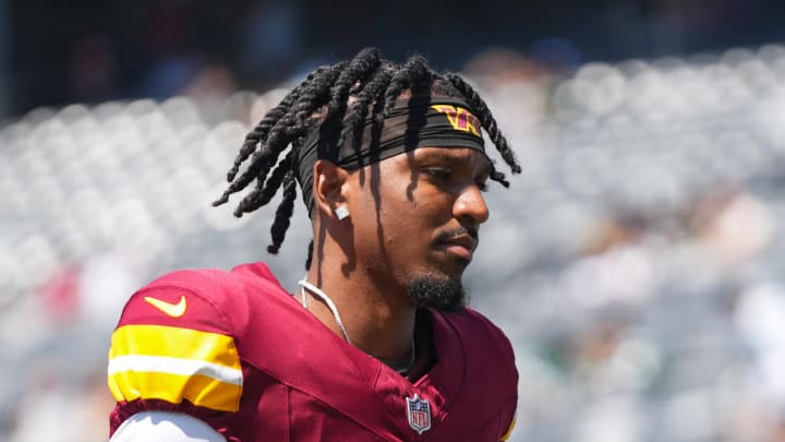 Aug 10, 2024; East Rutherford, New Jersey, USA; Washington Commanders quarterback Jayden Daniels (5) exits the field before the game against the New York Jets at MetLife Stadium. Mandatory Credit: Lucas Boland-USA TODAY Sports