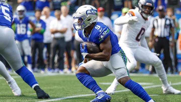 Sep 8, 2024; Seattle, Washington, USA; Seattle Seahawks running back Kenneth Walker III (9) rushes against the Denver Broncos during the first quarter at Lumen Field. Mandatory Credit: Joe Nicholson-Imagn Images