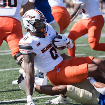 Sep 14, 2024; Tulsa, Oklahoma, USA;  Tulsa Golden Hurricane safety Devin Robinson (16) tackles Oklahoma State Cowboys running back Ollie Gordon II (0) during a game at Skelly Field at H.A. Chapman Stadium. Mandatory Credit: Brett Rojo-Imagn Images