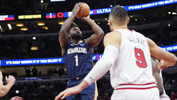 Jan 14, 2025; Chicago, Illinois, USA; Chicago Bulls center Nikola Vucevic (9) defends New Orleans Pelicans forward Zion Williamson (1) during the first quarter at United Center. Mandatory Credit: David Banks-Imagn Images
