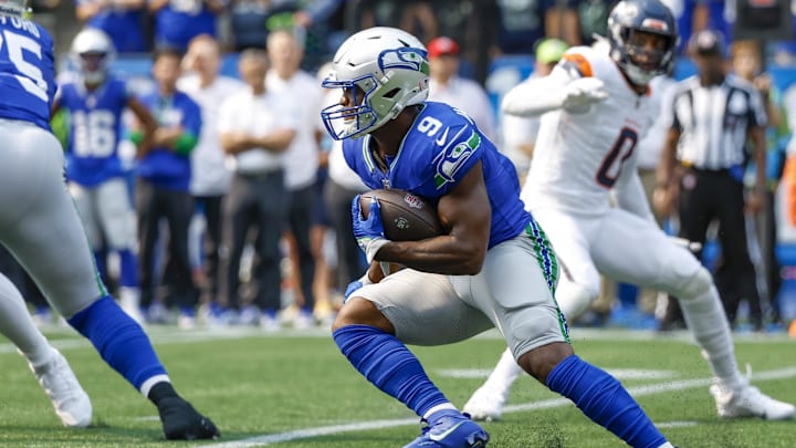 Sep 8, 2024; Seattle, Washington, USA; Seattle Seahawks running back Kenneth Walker III (9) rushes against the Denver Broncos during the first quarter at Lumen Field. Mandatory Credit: Joe Nicholson-Imagn Images