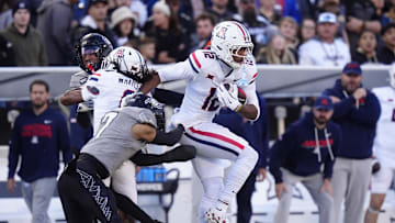 Nov 1, 2025; Boulder, Colorado, USA; Arizona Wildcats wide receiver Tre Spivey (12) runs for a touchdown past the tackle of Colorado Buffaloes defensive back Tawfiq Byard (7) in the first quarter at Folsom Field. Mandatory Credit: Ron Chenoy-Imagn Images
