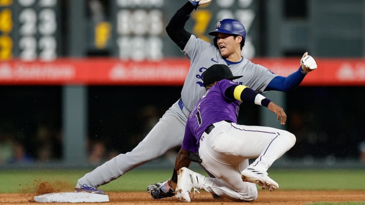 Jun 17, 2024; Denver, Colorado, USA; Los Angeles Dodgers designated hitter Shohei Ohtani (17) safely steals second against Colorado Rockies second baseman Adael Amador (1) in the eighth inning at Coors Field. Mandatory Credit: Isaiah J. Downing-USA TODAY Sports