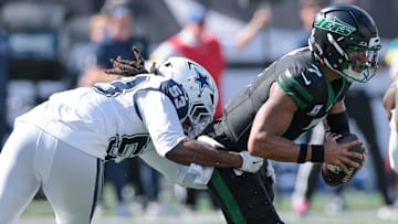 New York Jets quarterback Justin Fields (7) is sacked by Dallas Cowboys defensive end James Houston (53) during the first half at MetLife Stadium.