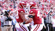 Arkansas Razorbacks tight end Rohan Jones (88) celebrates with tight end Maddox Lassiter (47) after accomplishing an immense feat of athleticism