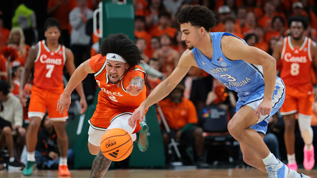 Feb 10, 2026; Coral Gables, Florida, USA; Miami Hurricanes guard Tre Donaldson (3) and North Carolina Tar Heels guard Derek Dixon (3) reach for a loose ball during the first half at Watsco Center. Mandatory Credit: Sam Navarro-Imagn Images Feb 10, 2026; Coral Gables, Florida, USA; Miami Hurricanes guard Tre Donaldson (3) and North Carolina Tar Heels guard Derek Dixon (3) reach for a loose ball during the first half at Watsco Center. Mandatory Credit: Sam Navarro-Imagn Images