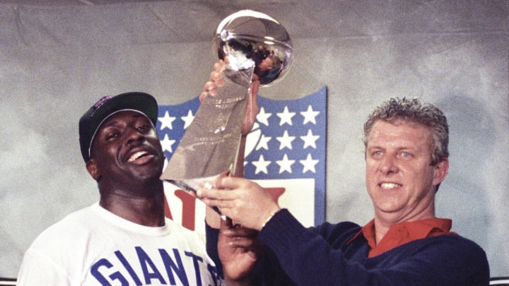 Jan 27, 1991; Tampa, FL, USA; FILE PHOTO; New York Giants head coach Bill Parcells and running back Ottis Anderson (24) with the Vince Lombardi Trophy after defeating the Buffalo Bills in Super Bowl XXV at Tampa Stadium. The Giants defeated the Bills 19-20. Mandatory Credit: Anne Ryan-USA TODAY Sports