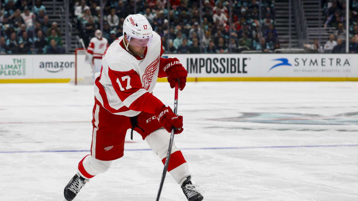 Feb 19, 2024; Seattle, Washington, USA; Detroit Red Wings right wing Daniel Sprong (17) shoots the puck against the Seattle Kraken during the first period at Climate Pledge Arena. Mandatory Credit: Joe Nicholson-USA TODAY Sports