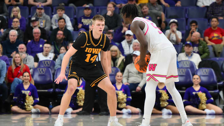 Feb 4, 2026; Seattle, Washington, USA; Iowa Hawkeyes guard Bennett Stirtz (14) guards Washington Huskies guard Zoom Diallo (5) during the second half at Alaska Airlines Arena at Hec Edmundson Pavilion. Mandatory Credit: Steven Bisig-Imagn Images