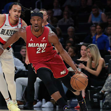 Jan 21, 2025; Miami, Florida, USA; Miami Heat forward Jimmy Butler (22) drives to the basket past Portland Trail Blazers guard Dalano Banton (5) during the first quarter at Kaseya Center. Mandatory Credit: Sam Navarro-Imagn Images