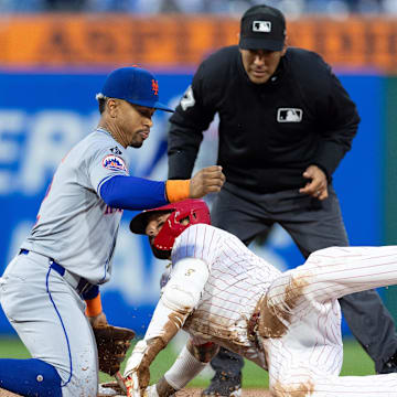 May 15, 2024; Philadelphia, Pennsylvania, USA; Philadelphia Phillies outfielder Nick Castellanos (8) is tagged out at second base by New York Mets shortstop Francisco Lindor (12) while attempting to stretch a single during the fourth inning at Citizens Bank Park. Mandatory Credit: Bill Streicher-Imagn Images