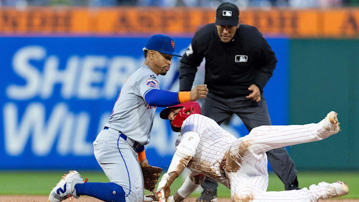 May 15, 2024; Philadelphia, Pennsylvania, USA; Philadelphia Phillies outfielder Nick Castellanos (8) is tagged out at second base by New York Mets shortstop Francisco Lindor (12) while attempting to stretch a single during the fourth inning at Citizens Bank Park. Mandatory Credit: Bill Streicher-Imagn Images