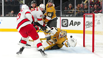 Nov 11, 2024; Las Vegas, Nevada, USA; Carolina Hurricanes center Jesperi Kotkaniemi (82) scores against Vegas Golden Knights goaltender Adin Hill (33) during the first period at T-Mobile Arena. Mandatory Credit: Stephen R. Sylvanie-Imagn Images
