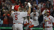 Oct 3, 2022; Pittsburgh, Pennsylvania, USA;  St. Louis Cardinals designated hitter Albert Pujols (5) reacts as he crosses home plate on a two run home run against the Pittsburgh Pirates during the sixth inning at PNC Park. The home run was the 703rd of Pujols career and the two runs batted in moved him into second place on the all-time MLB RBI list with 2216 runs batted in. Mandatory Credit: Charles LeClaire-Imagn Images