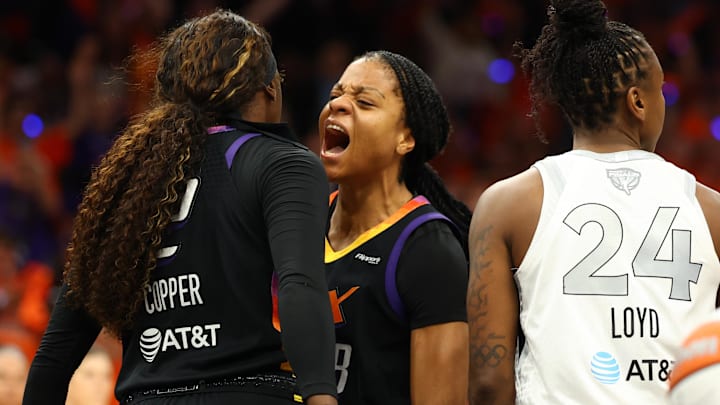 Oct 8, 2025; Phoenix, Arizona, USA; Phoenix Mercury guard Monique Akoa Makani (8) reacts with guard Kahleah Copper (2) against Las Vegas Aces guard Jewell Loyd (24) in the second half during game three of the 2025 WNBA Finals at PHX Arena. Mandatory Credit: Mark J. Rebilas-Imagn Images