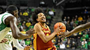 Dec 2, 2025; Eugene, Oregon, USA; Southern California Trojans forward Chad Baker-Mazara (4) drives to the basket between Oregon Ducks center Ege Demir (16) and forward Dezdrick Lindsay (4) during the second half at Matthew Knight Arena. 