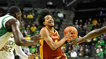 Dec 2, 2025; Eugene, Oregon, USA; Southern California Trojans forward Chad Baker-Mazara (4) drives to the basket between Oregon Ducks center Ege Demir (16) and forward Dezdrick Lindsay (4) during the second half at Matthew Knight Arena. 
