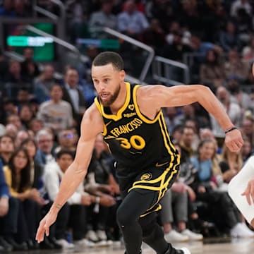 Mar 6, 2024; San Francisco, California, USA; Golden State Warriors guard Stephen Curry (30) dribbles past Milwaukee Bucks forward Giannis Antetokounmpo (34) in the third quarter at Chase Center.