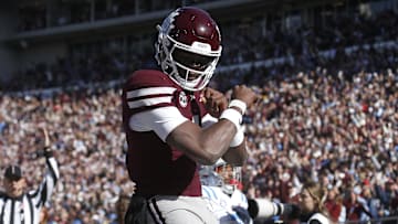 Mississippi State Bulldogs quarterback Kamario Taylor (1) celebrates after scoring a touchdown against the Mississippi Rebels in the first half at Davis Wade Stadium at Scott Field.