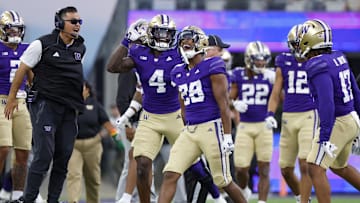 Sep 21, 2024; Seattle, Washington, USA; Washington Huskies linebacker Khmori House (28) celebrates with safety Justin Harrington (4) following an interception against the Northwestern Wildcats during the fourth quarter at Alaska Airlines Field at Husky Stadium. Mandatory Credit: Joe Nicholson-Imagn Images