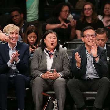 May 9, 2019; New York City, NY, USA; Taiwanese businessman Joe Tsai (center) cheers during the second half of the preseason WNBA game between the New York Liberty and the China National Team at Barclays Center. Mandatory Credit: Vincent Carchietta-Imagn Images