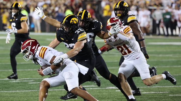 Sep 12, 2026; Iowa City, Iowa, USA;  Iowa State Cyclones quarterback Jaylen Raynor (1) is tackled by Iowa Hawkeyes linebacker Cam Buffington (33) during the third quarter at Kinnick Stadium.  Mandatory Credit: Reese Strickland-Imagn Images