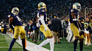 Notre Dame safety Xavier Watts (0), cornerback Christian Gray (29) and safety Adon Shuler (8) celebrate a Watts interception during a NCAA college football game against Virginia at Notre Dame Stadium on Saturday, Nov. 16, 2024, in South Bend.
