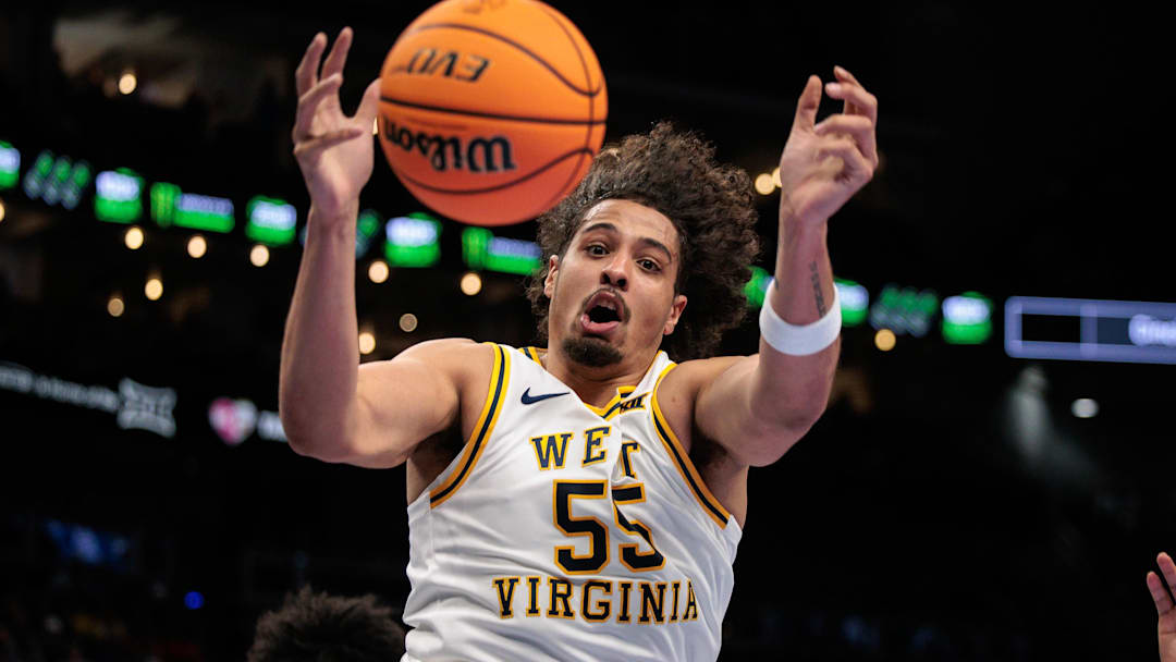 Mar 11, 2026; Kansas City, MO, USA; West Virginia Mountaineers center Harlan Obioha (55) loses control of the ball during the first half against the BYU Cougars at T-Mobile Center. Mandatory Credit: William Purnell-Imagn Images