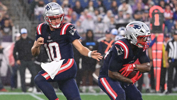 August 8, 2024; Foxborough, MA, USA;  New England Patriots quarterback Drake Maye (10) hands the ball to running back Antonio Gibson (21) during the first half against the Carolina Panthers at Gillette Stadium. Mandatory Credit: Eric Canha-USA TODAY Sports