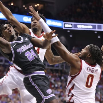 Kansas State junior forward Arthur Kaluma (24) looks for a shot around Iowa State in the first half of the quarterfinal round in the Big 12 Tournament inside the T-Mobile Center in Kansas City, Mo.