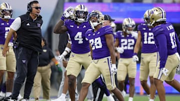 Sep 21, 2024; Seattle, Washington, USA; Washington Huskies linebacker Khmori House (28) celebrates with safety Justin Harrington (4) following an interception against the Northwestern Wildcats during the fourth quarter at Alaska Airlines Field at Husky Stadium. Mandatory Credit: Joe Nicholson-Imagn Images