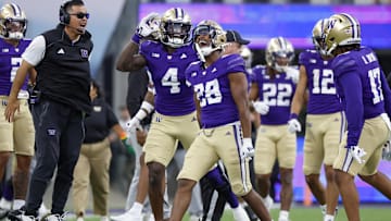 Sep 21, 2024; Seattle, Washington, USA; Washington Huskies linebacker Khmori House (28) celebrates with safety Justin Harrington (4) following an interception against the Northwestern Wildcats during the fourth quarter at Alaska Airlines Field at Husky Stadium. Mandatory Credit: Joe Nicholson-Imagn Images