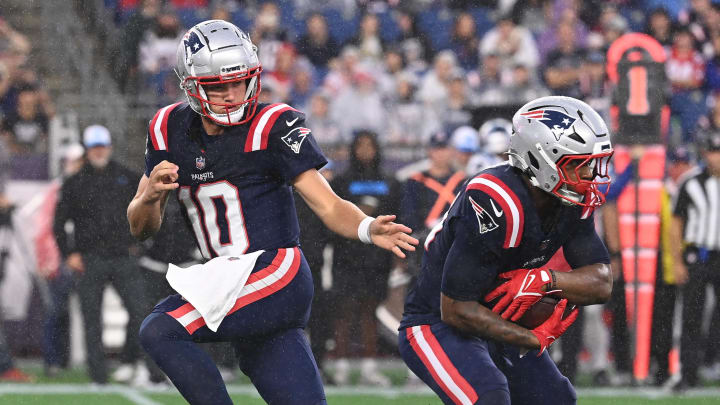 August 8, 2024; Foxborough, MA, USA;  New England Patriots quarterback Drake Maye (10) hands the ball to running back Antonio Gibson (21) during the first half against the Carolina Panthers at Gillette Stadium. Mandatory Credit: Eric Canha-USA TODAY Sports