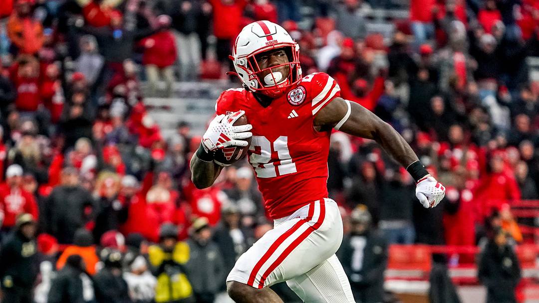 Oct 28, 2023; Lincoln, Nebraska, USA; Nebraska Cornhuskers running back Emmett Johnson (21) runs for a touchdown against the Purdue Boilermakers during the fourth quarter at Memorial Stadium. Mandatory Credit: Dylan Widger-Imagn Images